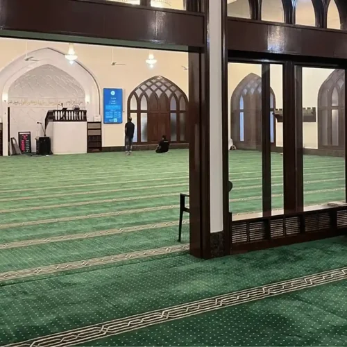 Durable mosque carpet with a deep color tone and structured layout.