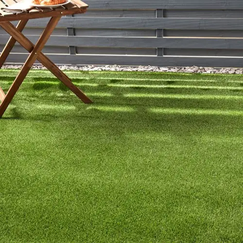 Kalahari artificial grass carpet with desert green hues and rugged, natural texture.