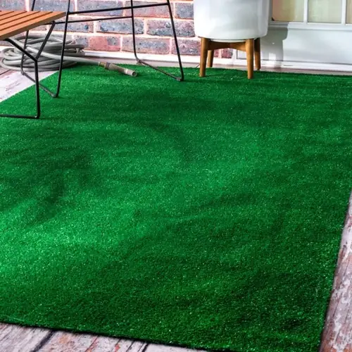 Lush green grass carpet perfect for indoor and outdoor use.