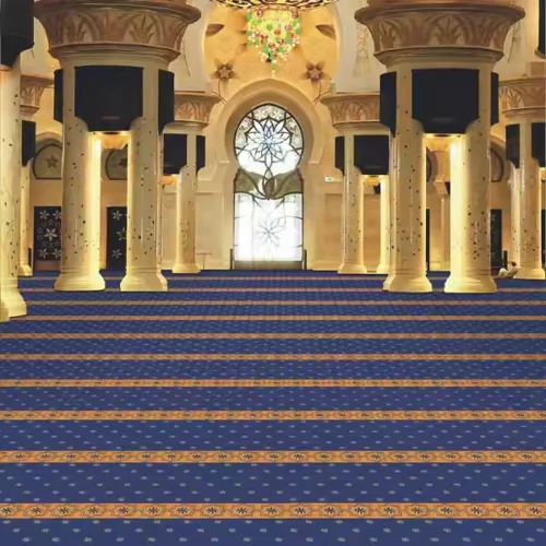 Elegant prayer carpet in a mosque, featuring arch designs and plush material.