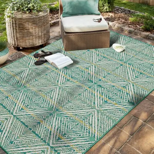 Tropical print outdoor carpet by poolside