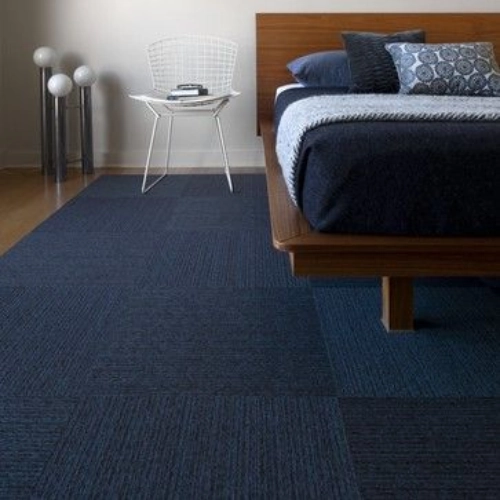 Vibrant cobalt blue carpet uplifting neutral-themed interiors.