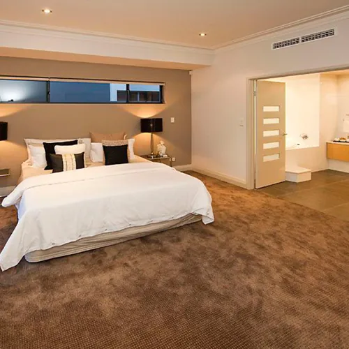 Wall-to-wall bedroom carpet in a soothing beige shade.