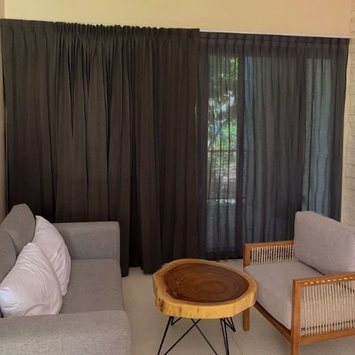 Blackout and sheer curtains installed in a modern Dubai living room, providing light control and privacy with stylish layered fabric.