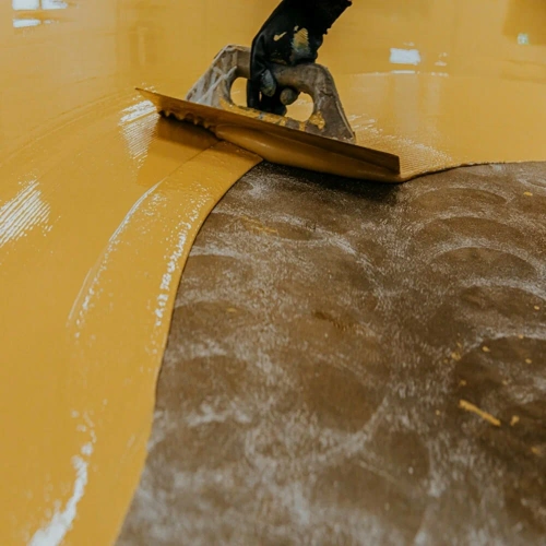 Chemical-resistant epoxy flooring in a laboratory setting, showing its seamless, durable surface designed to withstand spills and corrosive substances