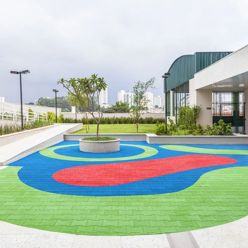 Colorful EPDM flooring in a modern Dubai school courtyard featuring green, blue, and red patterns designed for safe outdoor play and visual appeal.