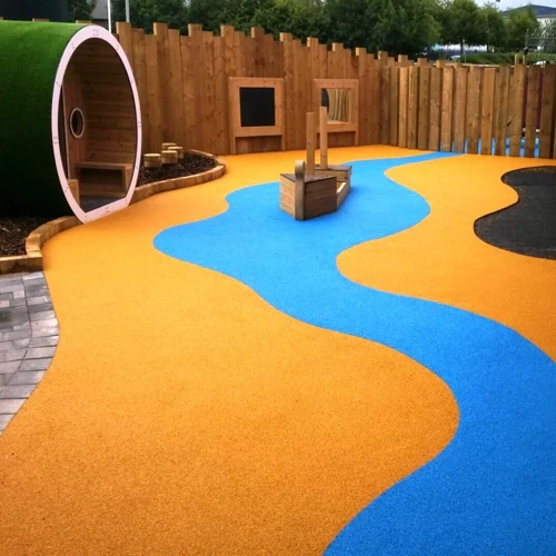 Colorful outdoor playground with a bright orange and blue rubber safety surface designed in a flowing river pattern