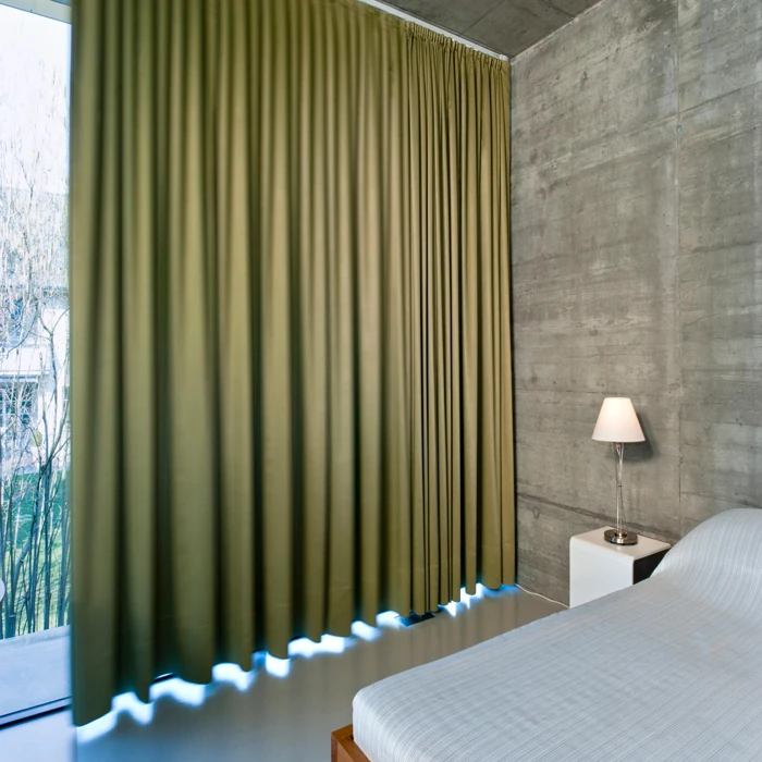 Contemporary green curtains for concrete wall bedroom.