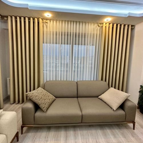 Contemporary living space with elegant window treatments.