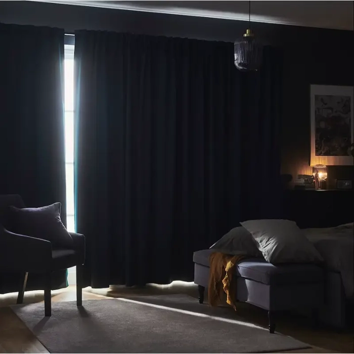 Dark blackout curtains ensuring peaceful bedroom sleep.