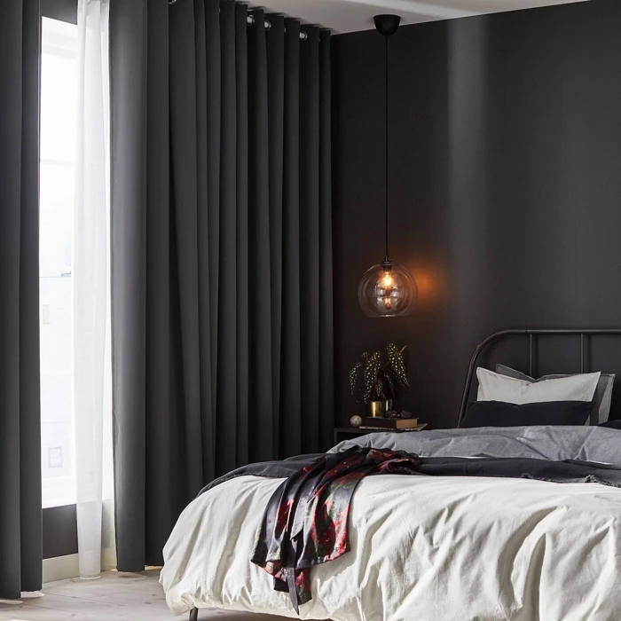 Dark grey curtains in modern bedroom, light filtering