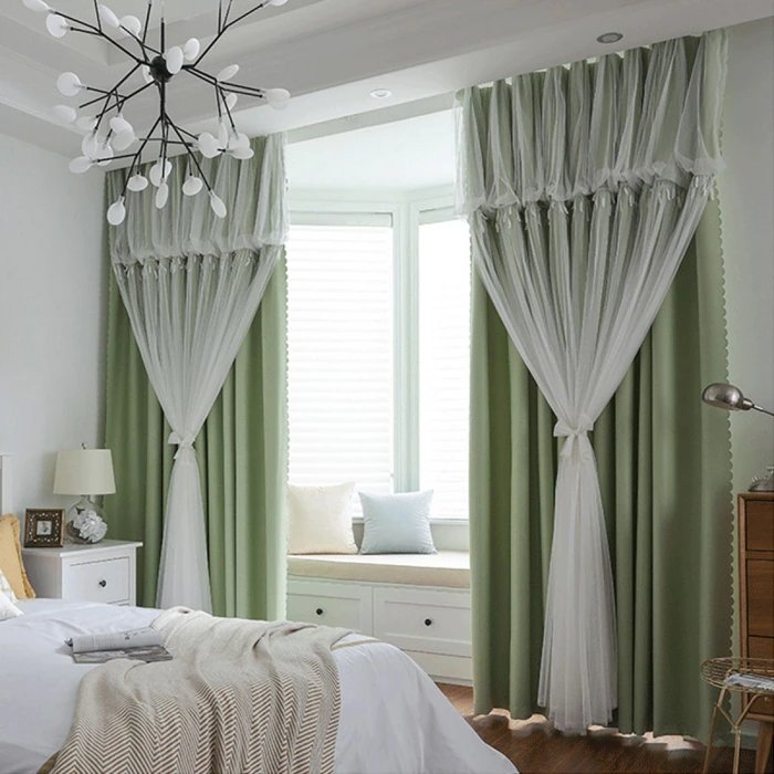 Elegant green curtains enhancing serene bedroom ambiance.