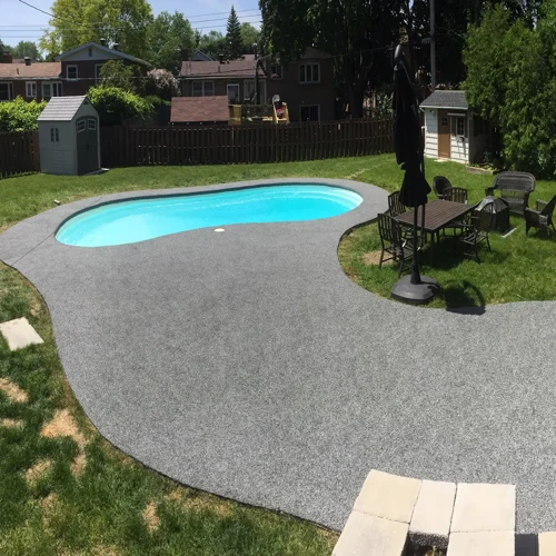 Grey EPDM rubber flooring around a backyard swimming pool in Dubai, providing a slip-resistant, water-drainage surface for safe outdoor use.