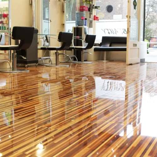High-gloss epoxy flooring reflecting overhead lights, showcasing a mirror-like, polished surface