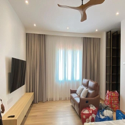 Layered brown and white curtains in modern living room.