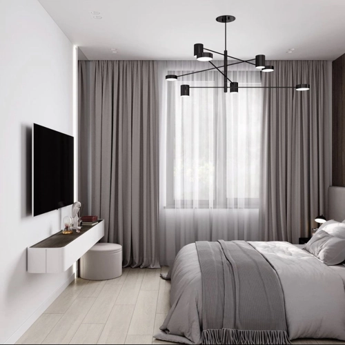 Modern bedroom with motorized sheer and gray curtains and a wall-mounted TV.