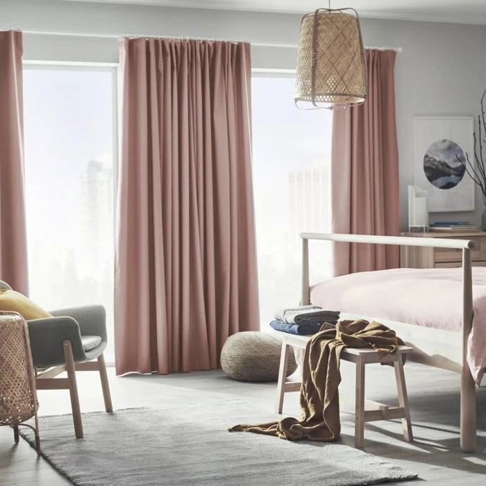 Soft pink curtains in bright, modern bedroom.