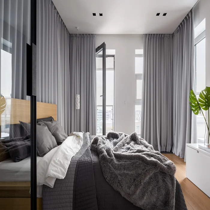 Stylish grey curtains in modern bedroom interior