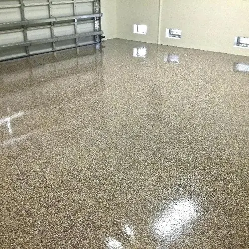 Textured quartz epoxy surface in a Dubai warehouse for enhanced traction and wear resistance