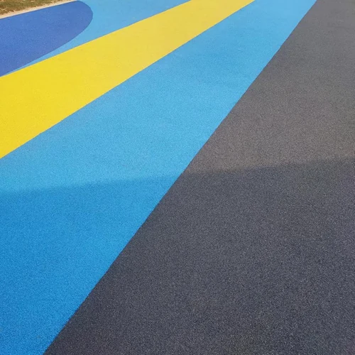 Vibrant EPDM rubber flooring in Dubai featuring bold blue, yellow, and black color patterns, ideal for running tracks