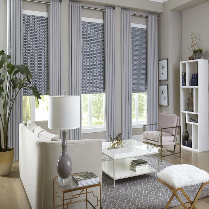 grey layered curtains with patterned roller blinds.