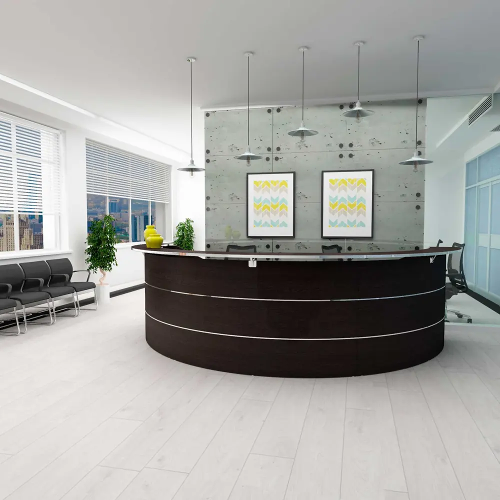 A contemporary office reception with a curved dark wood desk and concrete wall.