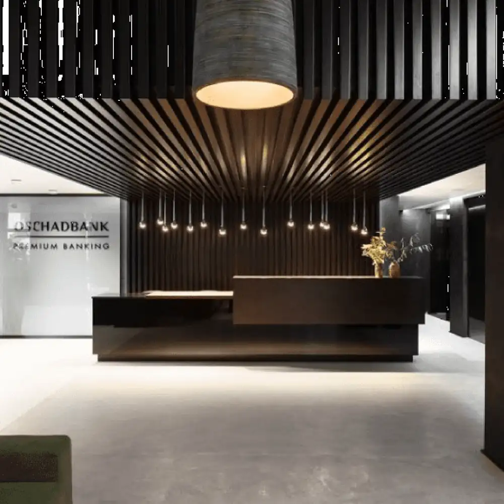 A luxurious banking reception with a dark wood slat ceiling and modern desk.