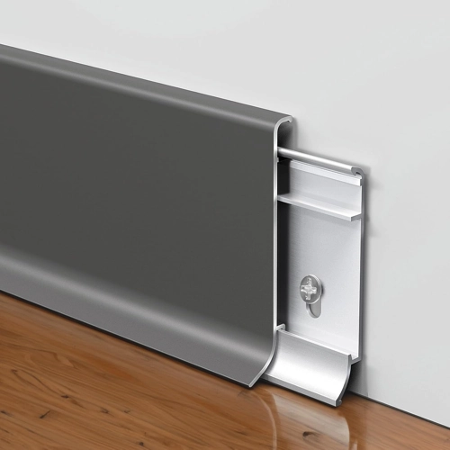 Dark gray aluminum skirting with a sleek, double-curved profile, showing its mounting clip system on a wall