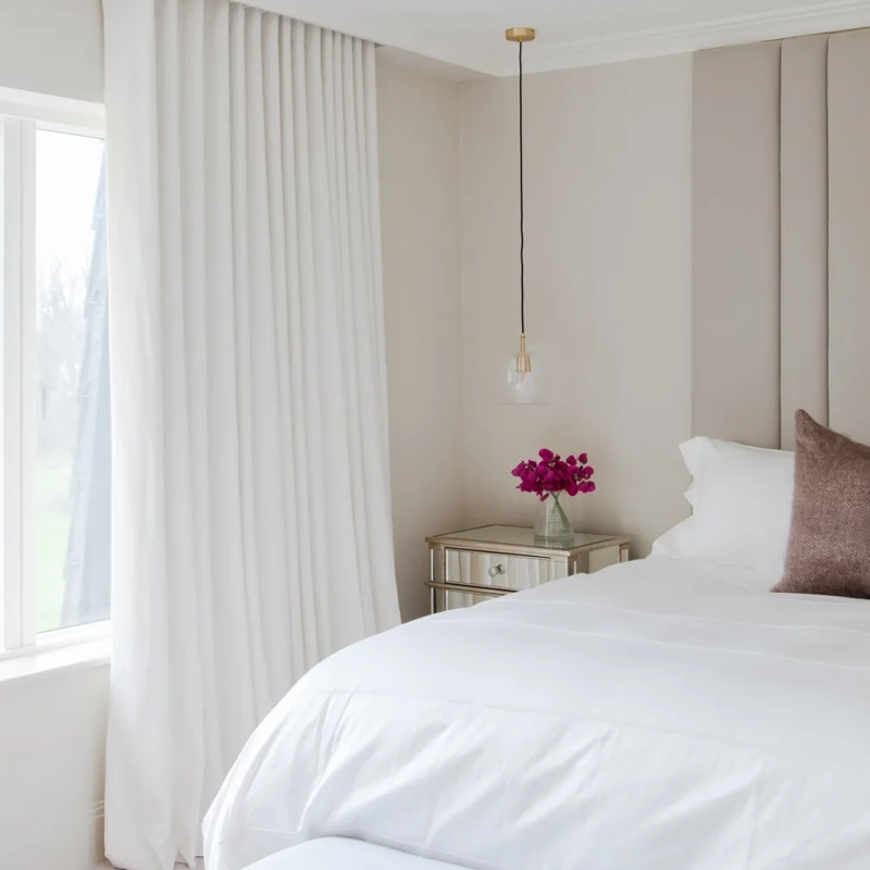 Layered blackout curtains in Dubai master bedroom