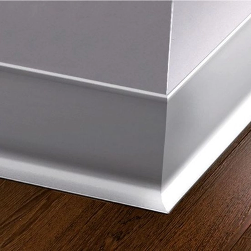 Silver skirting with a smooth, modern profile, complementing a dark wood floor.